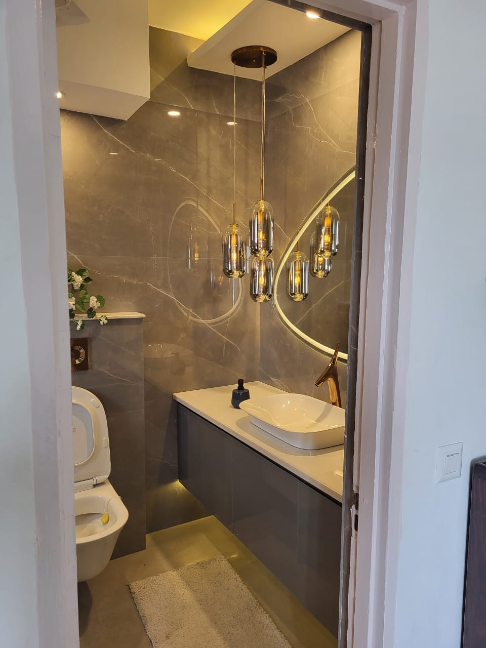 Full vanity view with warm brass fixtures